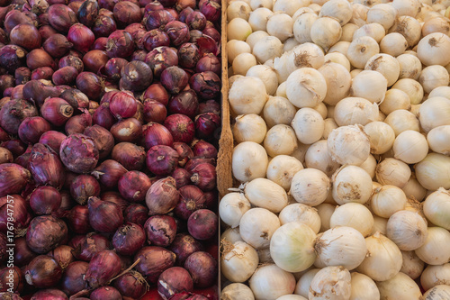 Fresh red and white onions on a market stall