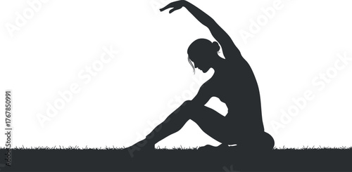 A graceful silhouette of a female figure performing yoga on a grassy surface.