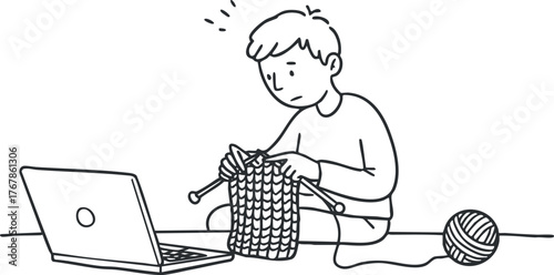 A young boy focused on knitting while using a laptop in a cozy environment.