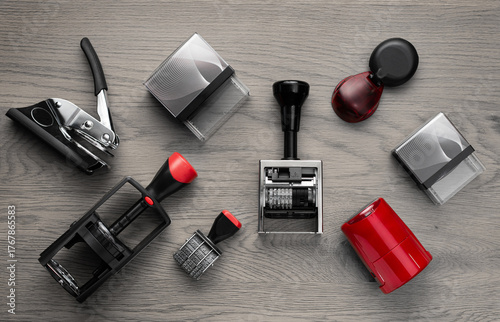 Various rubber stamps on wooden table, top view