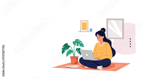 Young woman sitting cross-legged on a rug, working on her laptop with a houseplant nearby.