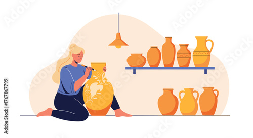 Woman decorating a large yellow vase with floral designs in a pottery studio setting.