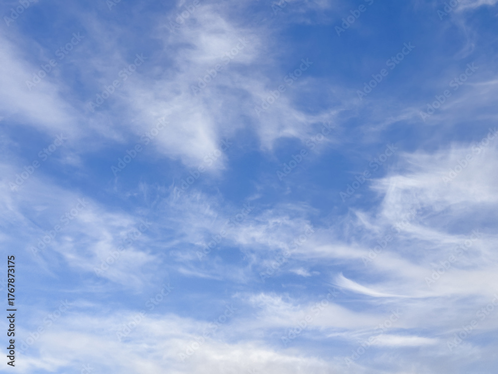 Obraz premium Swirling High Altitude Cirrus Clouds in Deep Blue Sky