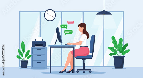 Woman working at desk focused on computer in office environment.