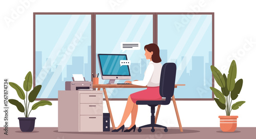 Woman working at desk in office with computer and plants.