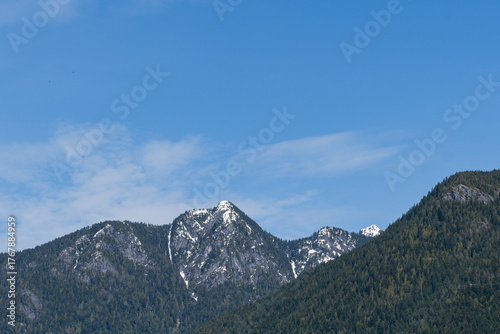 mountain peaks with snow-capped peaks and bright blue skies