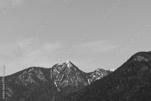 black and white mountain peaks with snow-capped peaks and bright blue skies