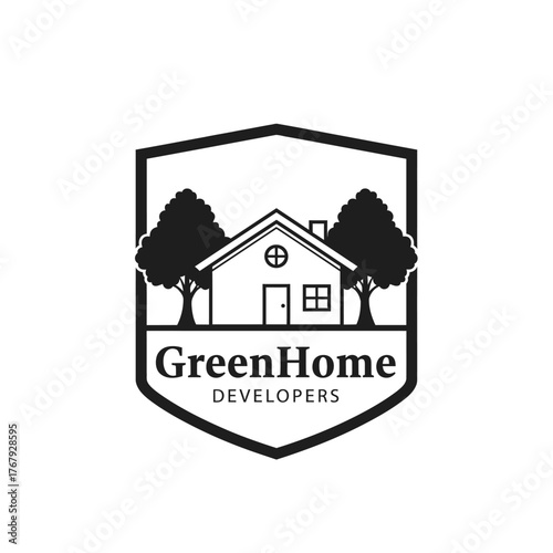 A black and white emblem featuring a house with two trees and text. It's enclosed in a shield shape