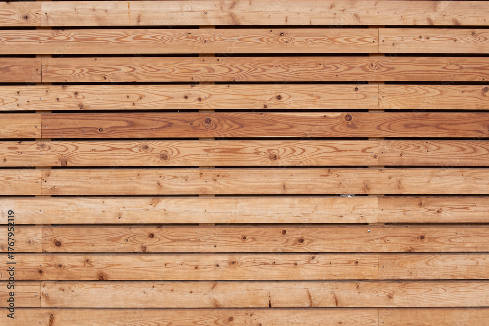 Fototapeta premium A wooden wall with a grainy texture