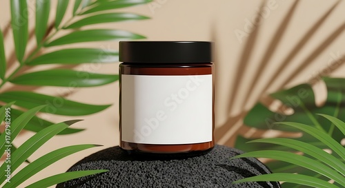 Amber cosmetic jar with black lid placed on stone among tropical palm leaves and soft warm lighting