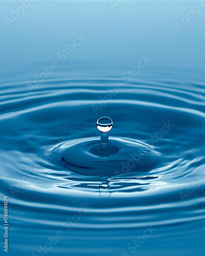 single water drop, ripple effect, liquid splash, water impact, concentric circles, expanding rings, fluid dynamics, surface tension, macro photography, water photography, nature close-up, droplet 