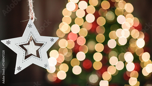 Christmas Star decoration with blurred tree