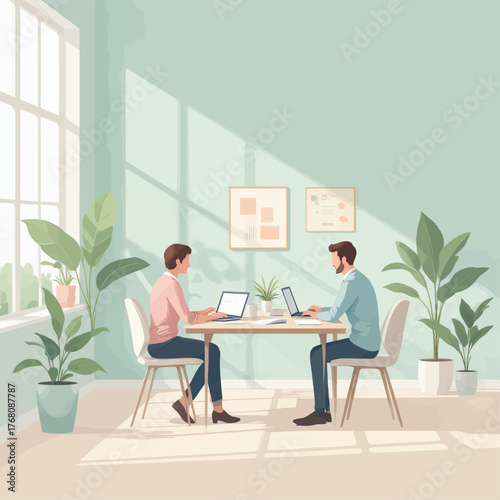 Two colleagues working remotely at shared desk with plants and sunlight