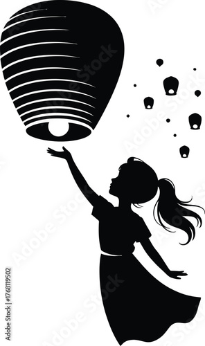 Silhouette of a girl releasing a glowing sky lantern into the night sky