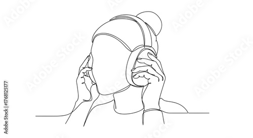 Hands putting on earmuffs symbolizing warmth and winter comfort