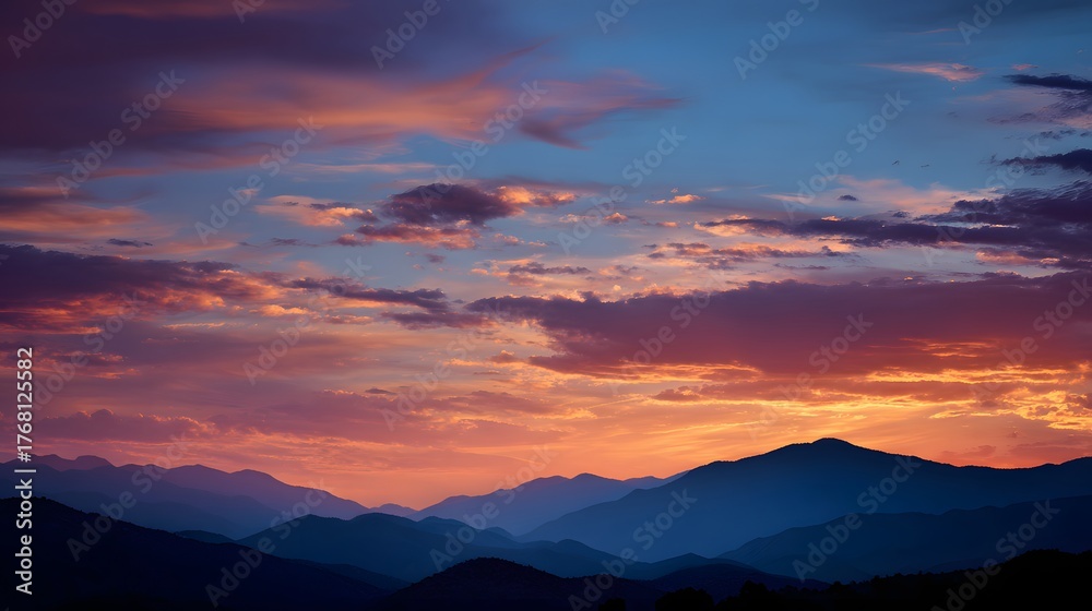 Obraz premium Layered mountain silhouettes contrast against a vibrant, colorful twilight sky.