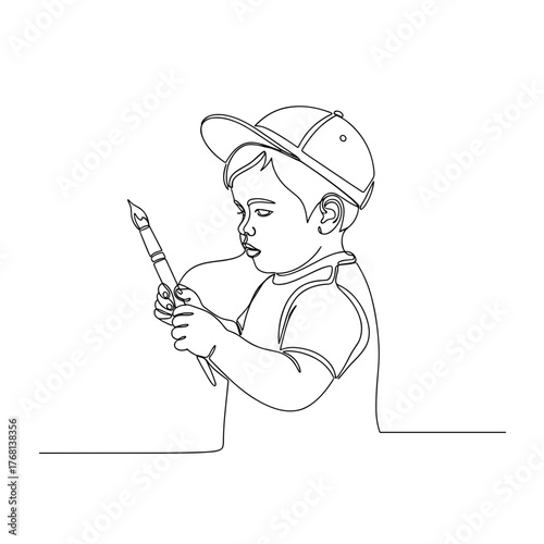Toddler holding paintbrush symbolizing exploration and imagination