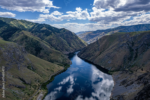 Drone photo of calm surface of Snake river, Hells Cayon. Clouds reflection in blue water