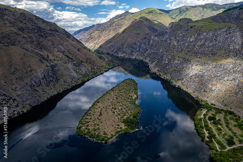 Drone photo of calm surface of Snake river, Hells Cayon. Clouds reflection in blue water