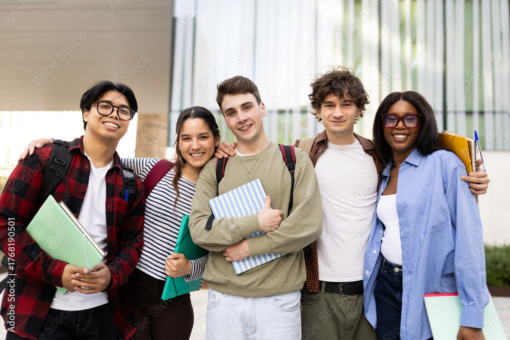 Obraz premium Happy university or high school students hugging and holding books