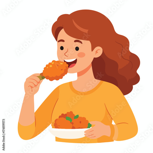A smiling woman with wavy brown hair eating a piece of fried chicken while holding a plate of more chicken.