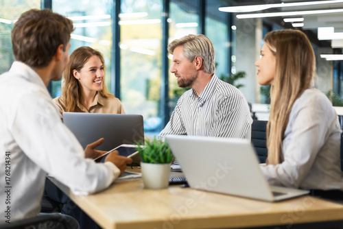 Wallpaper Mural Group of confident business people in smart casual wear working together while sitting at the desk in office Torontodigital.ca
