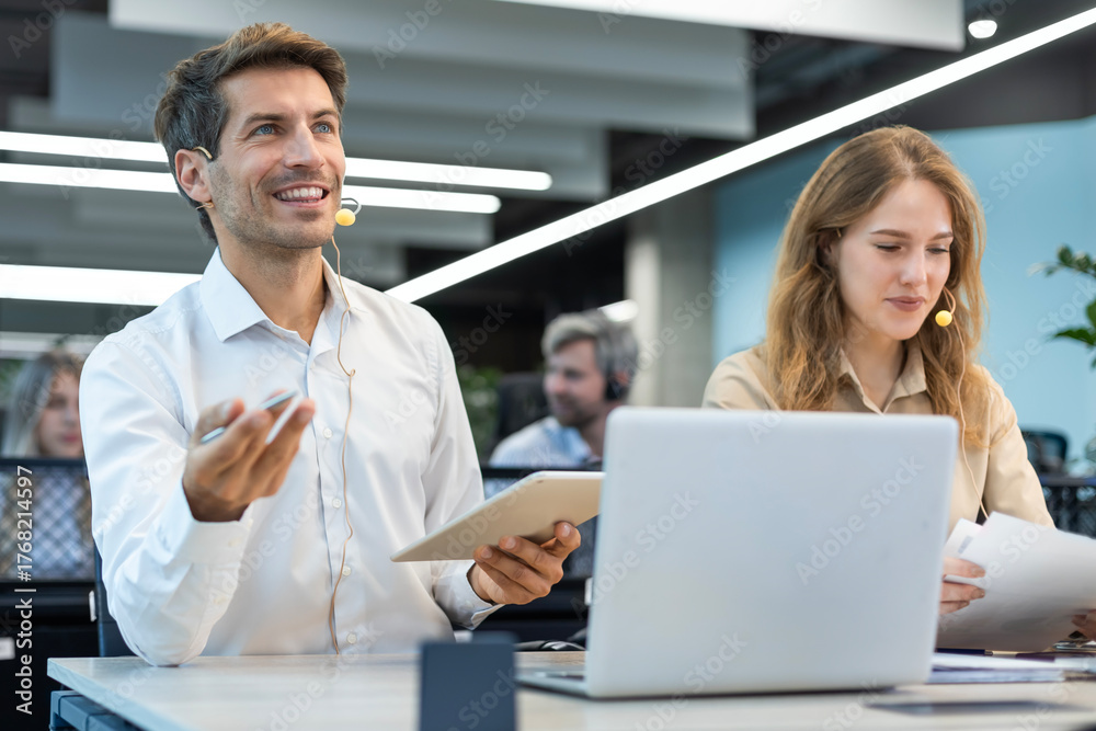 Obraz premium Happy young male customer support executive working in office.