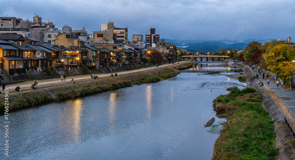 Fototapeta premium Scenic sight along the Kamo river in Kyoto in the early evening. Kyoto, Japan, October-25-2024
