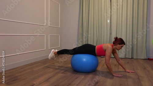 middle-aged woman doing sports exercise on the floor at home