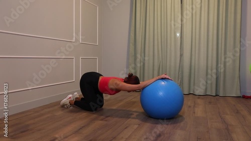 middle-aged woman doing sports exercise on the floor at home
