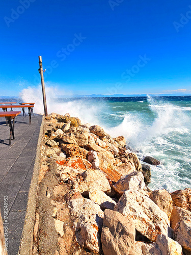 Waves breaking on a stone wall on the promenade 