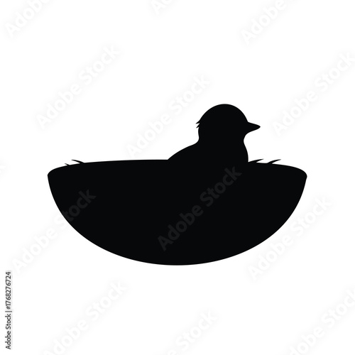 Black silhouette of a bird sitting in its nest on white background