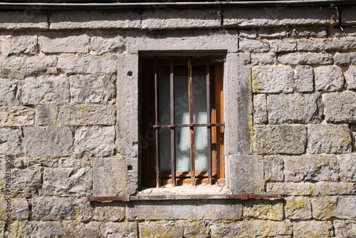 Old Window in Brick Wall
Weathered window framed by aged, cracked, and neglected bricks.
