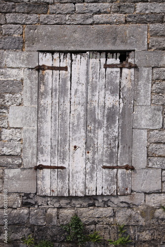 Old Window in Brick Wall
Weathered window framed by aged, cracked, and neglected bricks.
