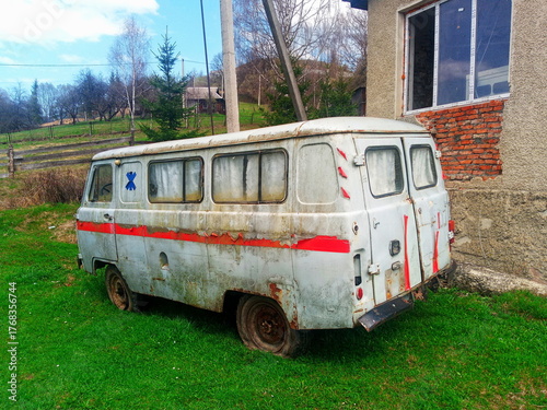 Abandoned old ambulance van in rural yard