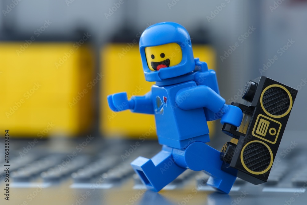 Obraz premium Tambov, Russian Federation - May 30, 2025 Blue Lego astronaut minifigure running with boombox. Close-up