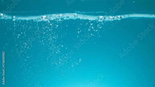 Underwater view of blue liquid with bubbles rising. Clean, fresh, tranquil scene