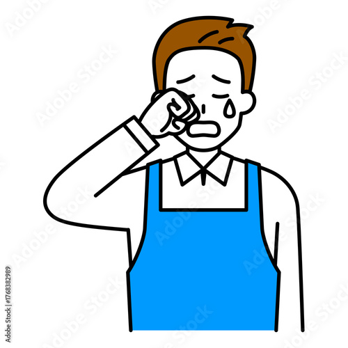 泣くエプロン姿の男性