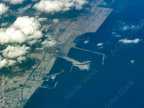 aerial landscape view of coastline along Fujairah, capital of Emirate of Fujairah,  United Arab Emirates with Port of Fujairah and industrial area,  located in the Gulf of Oman