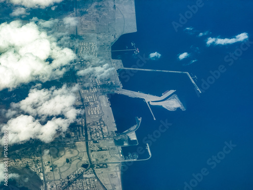 aerial landscape view of coastline in Fujairah, located at Gulf of Oman, with Port of Fujairah, Fujairah Oil Industry Zone, streets, buildings and other infrastructure