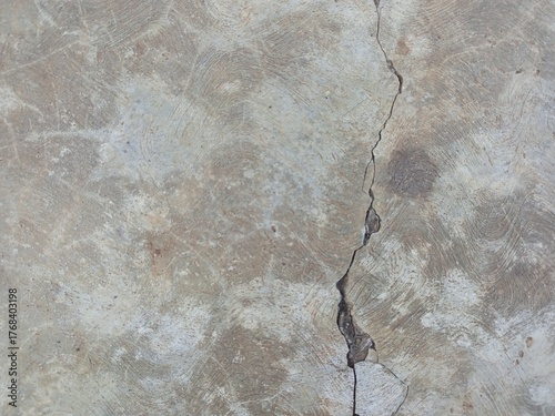 Long vertical crack in gray concrete floor texture