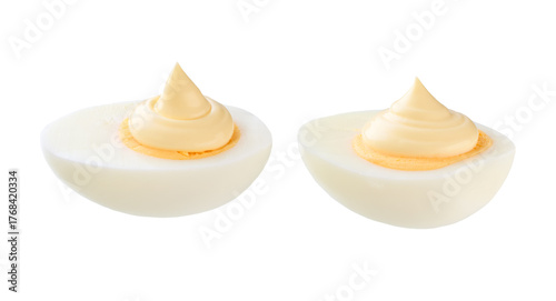 Half a boiled chicken egg with mayonnaise isolated on a white background.