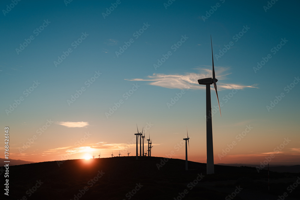 Obraz premium Wind turbines at sunset over hills, Spain