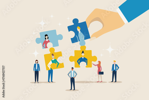 Hand placing a puzzle piece with a person into a larger team puzzle