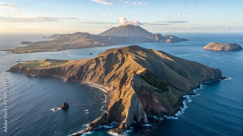 Aerial View of Volcanic Island with Mountain Peaks and Blue Ocean – Dramatic Natural Landscape at Sunrise