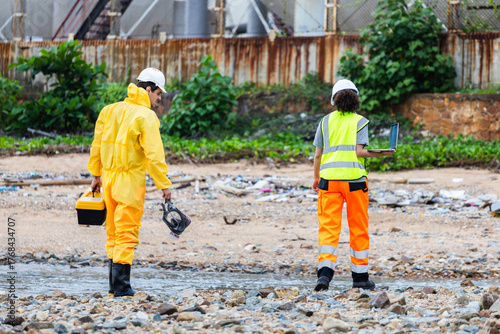 Environmental Workers Inspecting Industrial Site, Team in Protective Gear Surveying Contaminated Area, Engineers Assessing Safety at Chemical Plant