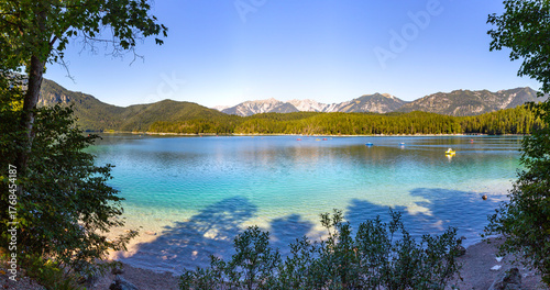 panorama from the beach of Lake Walchensee in summer with mountains in background