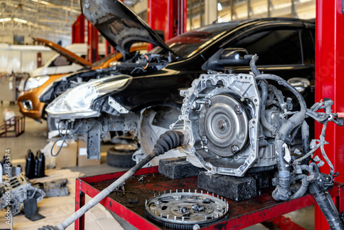 Automatic transmission system disassembled on a workbench in a professional auto repair garage. focus on car service and vehicle maintenance.