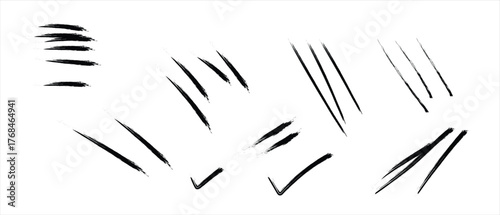 Assorted black ink brush stroke marks and symbols on white background lines checkmark