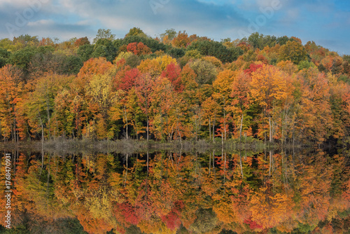 Autumn landscape of the shoreline of West Twin Lake with mirrored reflections in calm water, Kalamazoo, Michigan, USA